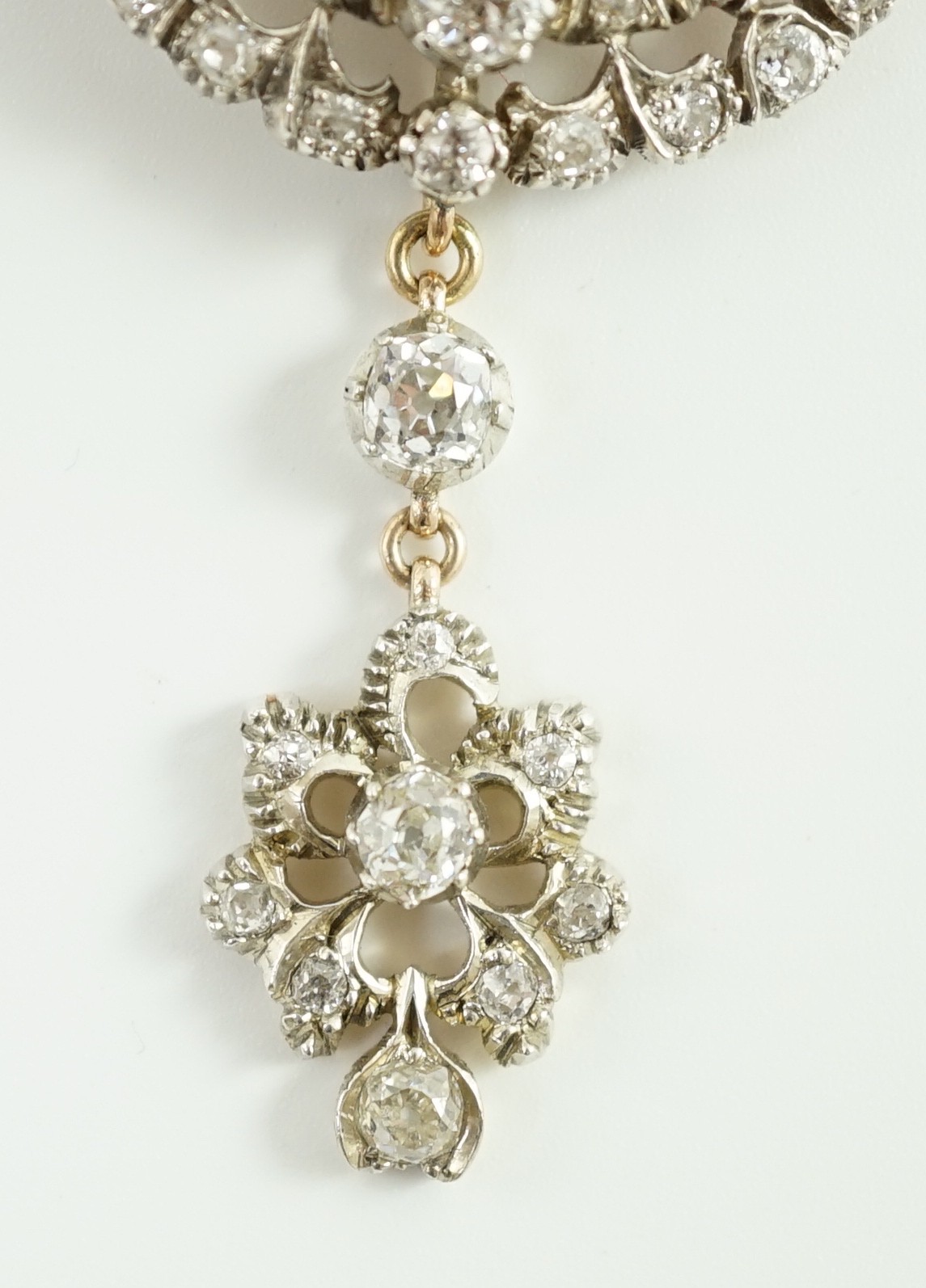 A good Victorian gold, silver and graduated diamond cluster set target drop pendant brooch, retailed by Carlo & Arthur Giuliano